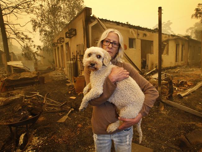 Mallacoota Fires. Jann Gilbert with her dog Ollie visits the site of her burnt out unit.           Picture: David Caird