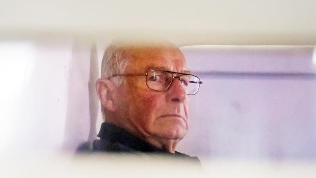 Roger Rogerson inside a police truck being taken into Bankstown Court to face charges relating to the murder of Jamie Gao. Picture: Craig Greenhill
