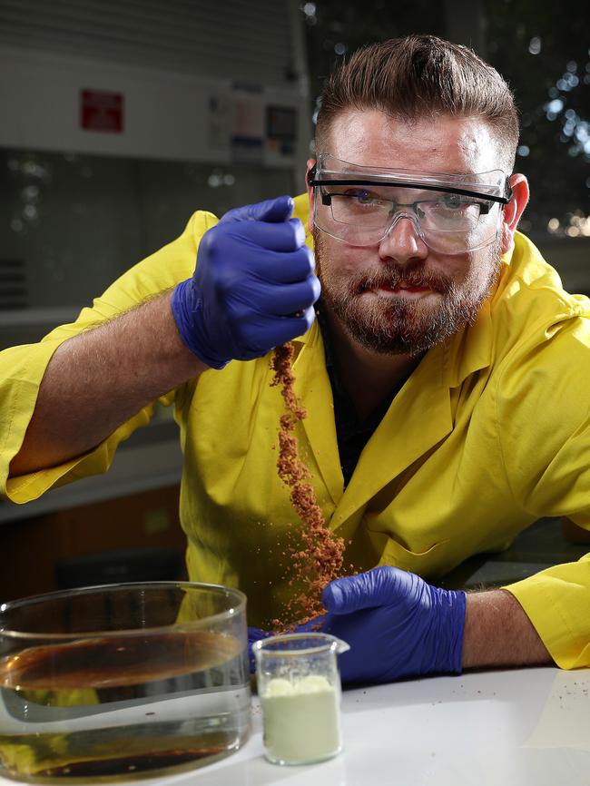 Synthetic chemistry senior lecturer Dr Justin Chalker adding his patented polymer to a sample of crude oil in his lab. Picture: Dylan Coker