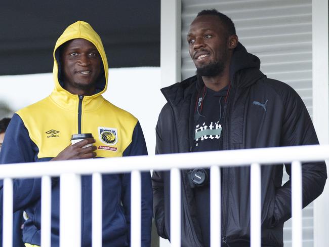 Usain Bolt (right) with Central Coast Mariners player Kalifa Cisse at Pluim Park, Lisarow on Sunday. Picture: Tim Pascoe