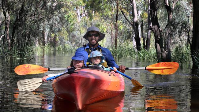 Hayden Dreckow and his kids, Eva, 4, and William, 2, enjoying a paddle what’s normally a walking trail in Berri. Picture Dean Martin