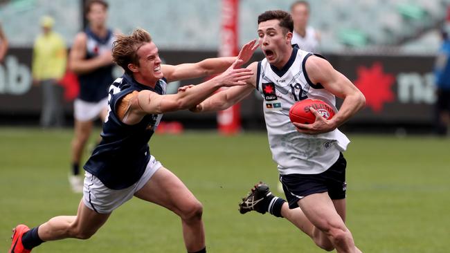 Lachlan Ash evades a tackle while playing for Vic Country.