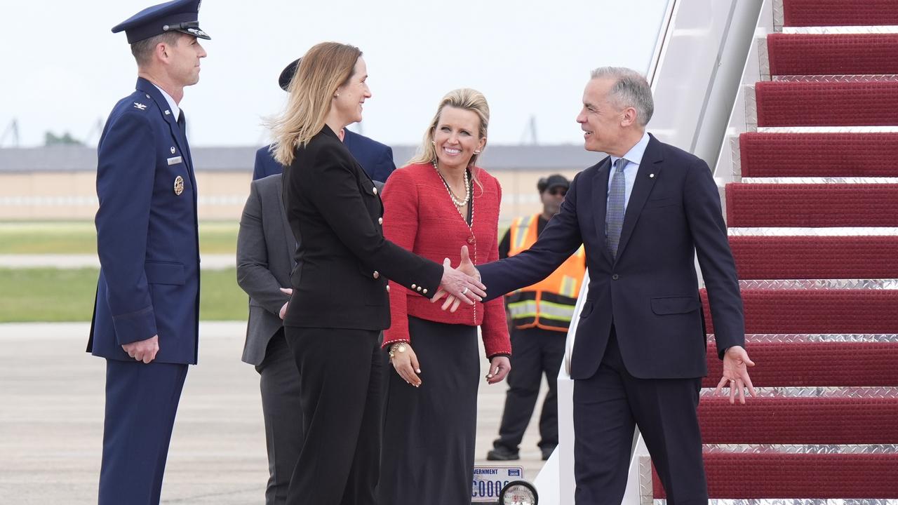 Canada's Prime Minister Mark Carney, right, is greeted by Canadian Ambassador to the U.S. Kirsten Hillman, second left, U.S. Acting Chief of Protocol Abby Jones, and U.S. Col. Randall J. Heusser after he disembarks a government plane Monday, May 5, 2025, as he arrives in Washington. (Adrian Wyld/The Canadian Press via AP)