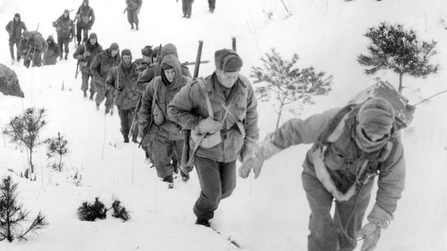 Australian soldiers patrolling in deep snow 20 kilometers into enemy territory. Many returned from patrols suffering from acute snow glare. Picture: A. Gulliver/SLV