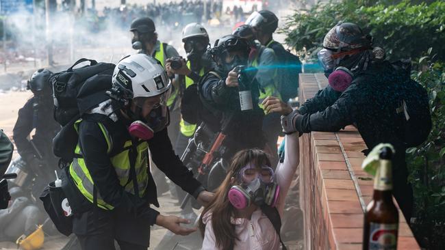 Protesters try to run the police gauntlet outside the Hong Kong Poytechnic University on Monday. Picture: Getty Images