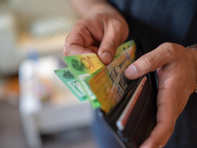 a male taking money out of the valet.