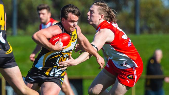 tigers’ Kieran Lovell evades the outstretched arm of Clarence’s Noah Holmes. Picture: SOLSTICE DIGITAL