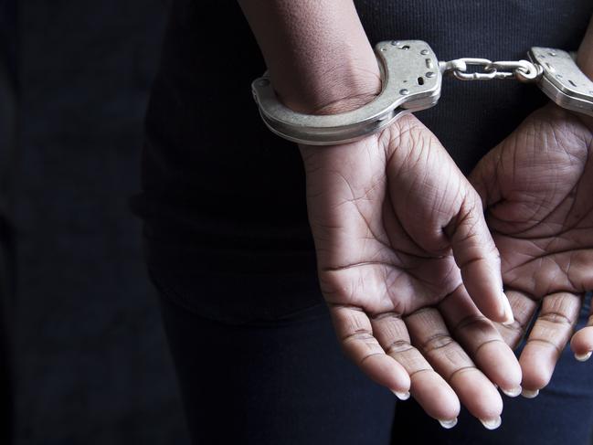 Black woman in handcuffs stock image