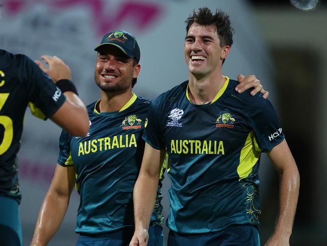 ANTIGUA, ANTIGUA AND BARBUDA - JUNE 20: Pat Cummins of Australia celebrates with teammates Marcus Stoinis and Mitchell Starc after dismissing Taskin Ahmed of Bangladesh (not pictured) for his hat trick during the ICC Men's T20 Cricket World Cup West Indies & USA 2024 Super Eight match between Australia and Bangladesh at Sir Vivian Richards Stadium on June 20, 2024 in Antigua, Antigua and Barbuda. (Photo by Jan Kruger-ICC/ICC via Getty Images)