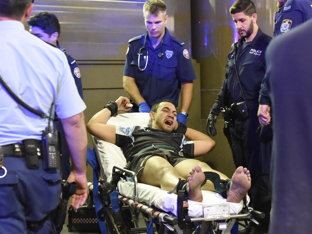 An extremely aggresive man, thought to be under the influence of methamphetamine is finally restrained to a stretcher after a group of up to 10 NSW Police and ambulance officers struggled to subdue him. Picture: Gordon McComiskie