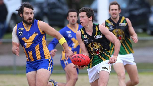 Dromana’s Dean Waugh about to shoot off a handball against Somerville on Saturday. Picture: Hamish Blair