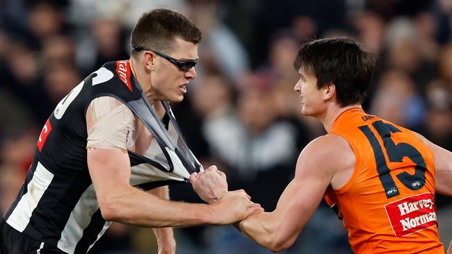 MELBOURNE, AUSTRALIA - SEPTEMBER 22: Mason Cox of the Magpies engages with Sam Taylor of the Giants after a goal during the 2023 AFL First Preliminary Final match between the Collingwood Magpies and the GWS GIANTS at Melbourne Cricket Ground on September 22, 2023 in Melbourne, Australia. (Photo by Dylan Burns/AFL Photos via Getty Images)