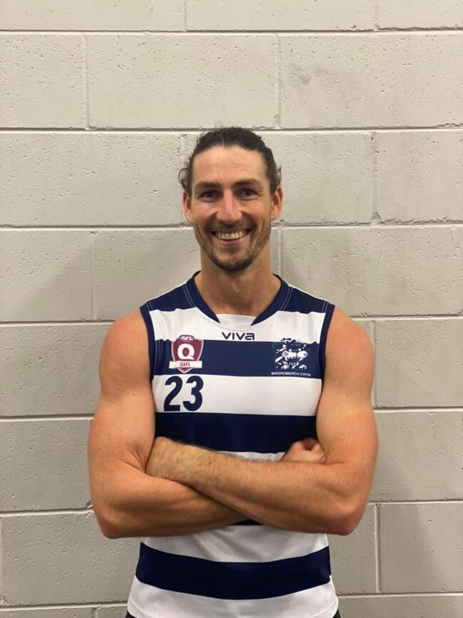 The Broadbeach Cats will revert to their iconic blue and white hoops this season. Recruit Jordan Moncrieff tries on the new stripe. Pic: Supplied.