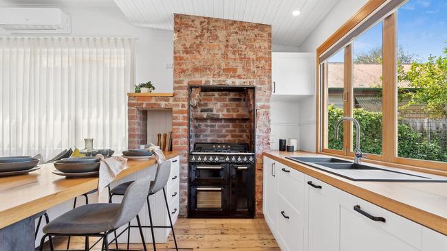 The Smeg cooker is set in the original brick fireplace in the kitchen.