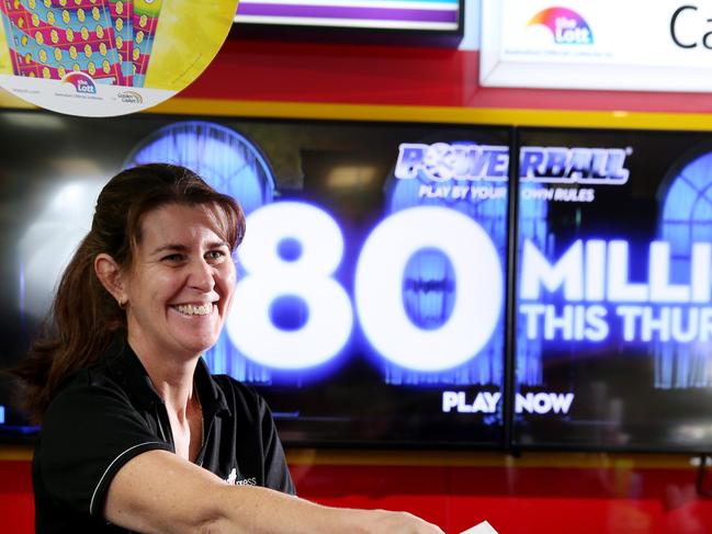 Karen Webb serves a customer a ticket for Thursdays $80 million Powerball draw. Picture: Stuart McLean