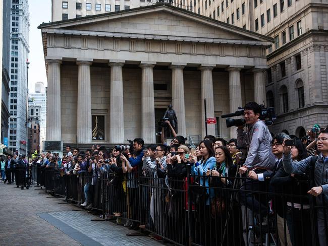 NEW YORK, NY - SEPTEMBER 19: Media and fans of Alibaba Group wait outside the New York Stock Exchange while executives of the company leave the building after the company's initial public offering (IPO) on September 19, 2014 in New York City. The New York Times reported yesterday that Alibaba had raised $21.8 Billion in their initial public offering so far. Andrew Burton/Getty Images/AFP == FOR NEWSPAPERS, INTERNET, TELCOS & TELEVISION USE ONLY ==