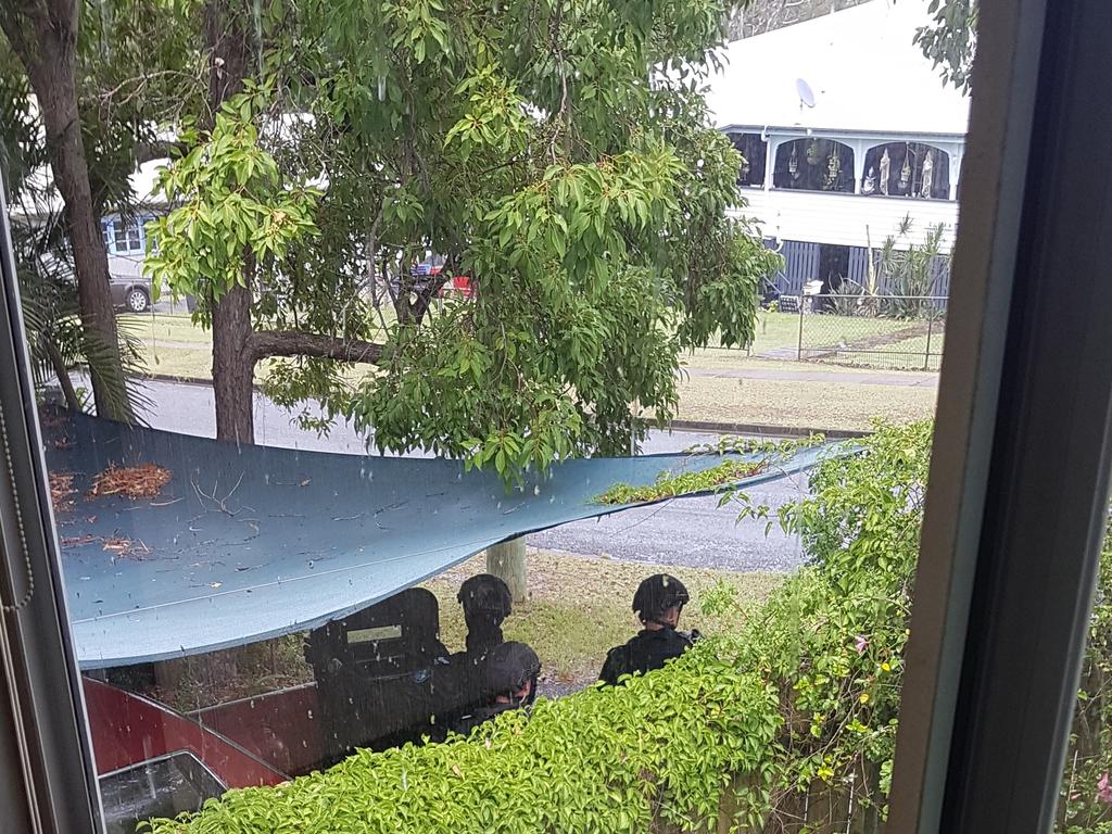 A neighbour took this picture of armed police officers during from inside his property.