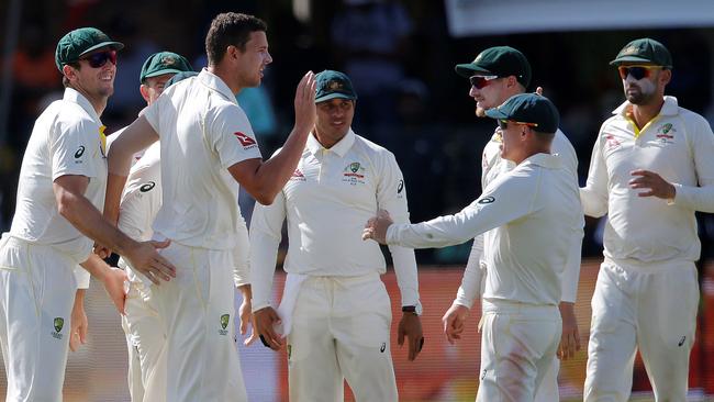 Josh Hazlewood and team-mates celebrate the wicket of Dean Elgar. Picture: AFP