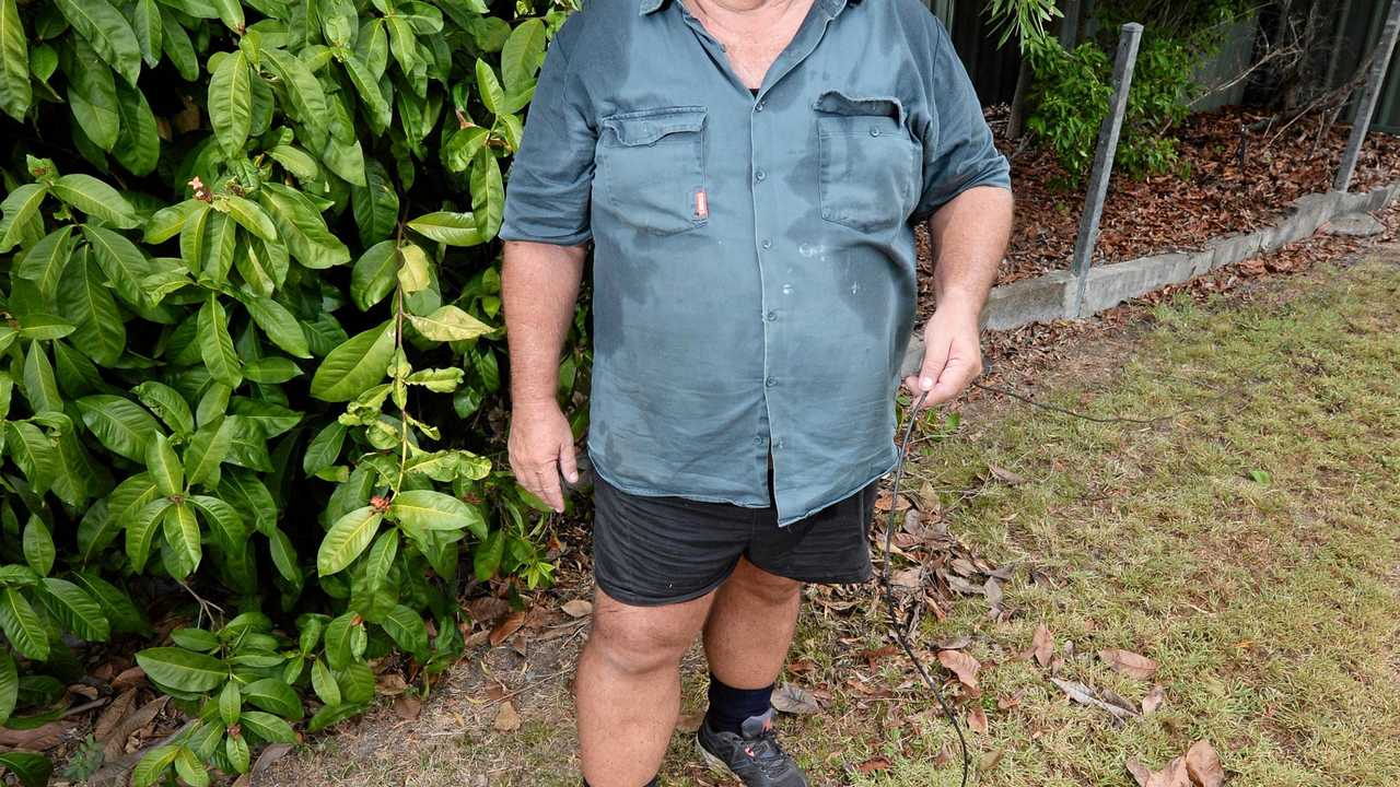 FRUSTING SITUATION: Jeff Beal has lived for the past six years with a temporary fix to his phone line with a cable which runs from the manhole, across the lawn and along a fence to his property. Picture: Chris Ison ROK020218cline3