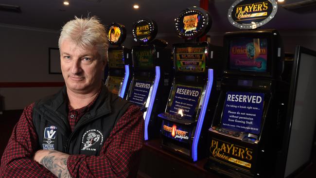 Dolphins Football Club general manager Brett Angwin with the poker machines at the club, which have been switched off. Picture: Chris Eastman