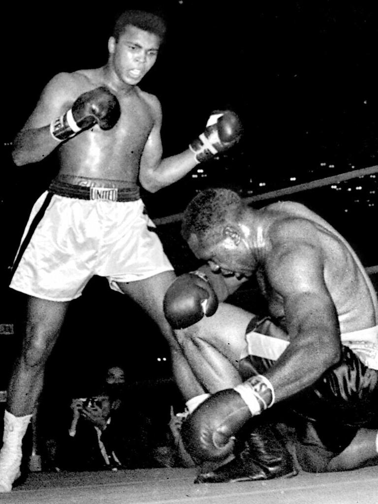 November 15, 1962: A young Ali stands over boxing legend Archie Moore in the fourth round of a 12-round fight. Ali won by a knockout.