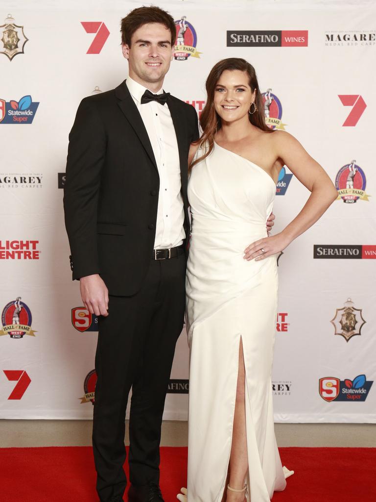 Lewis Johnston and Rachael Johnston, wearing Lelle Zetoni, pose for a picture on the red carpet at Adelaide Oval in North Adelaide, for the Magarey Medal, Monday, September 9, 2019. Picture: Matt Loxton