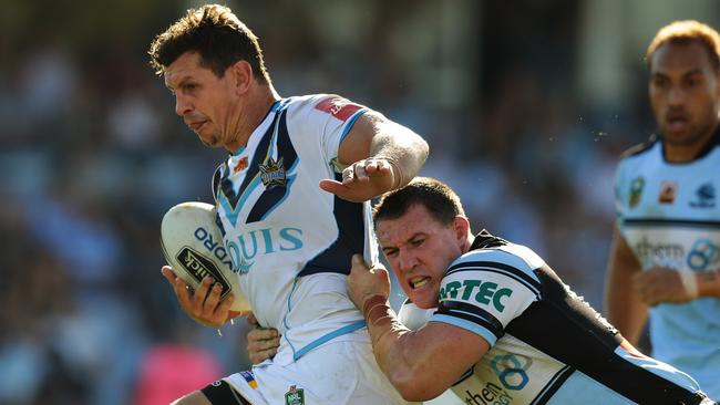 Titans Greg Bird is tackled by Cronulla's Paul Gallen during the Cronulla Sharks v Gold Coast Titans rugby league game at Shark Park, Cronulla. Pic Brett Costello