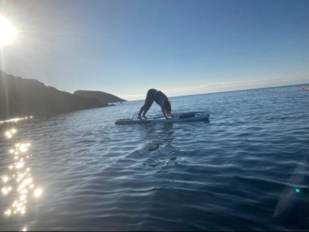 UK TV star Carol Vordermon, 61, shows off her yoga paddleboarding skills with a quick downward dog. Picture: Instagram/Carol Vorderman