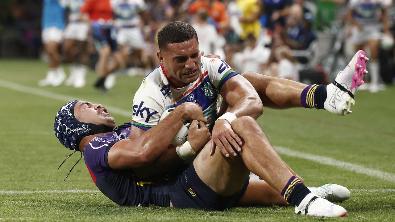 Marcelo Montoya of the Warriors is tackled by Jahrome Hughes of the Storm preventing a try. Picture: Getty Images