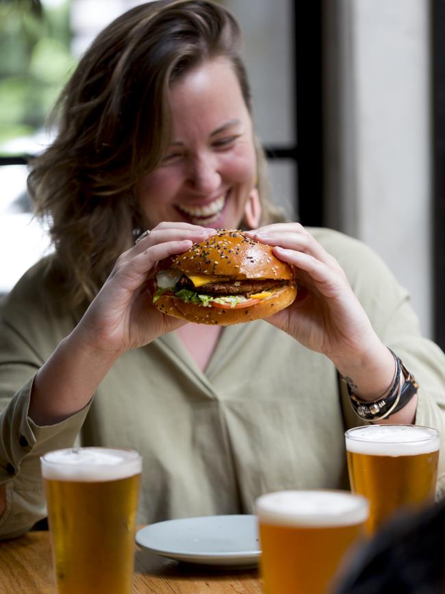 Katie Wilton enjoying a Beyond Burger patty at Newmarket Hotel in St Kilda.