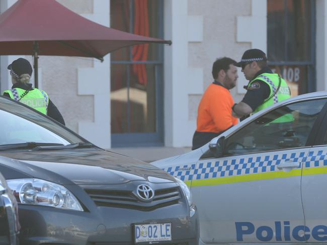 Police arrive at the hotel where Tony Abbott was staying in Hobart. Picture: Luke Bowden