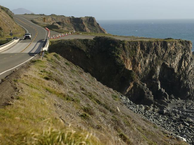 A truck drives by the pullout where the SUV of Jennifer and Sarah Hart was recovered off the Pacific Coast Highway, near Westport, California. Picture: AP