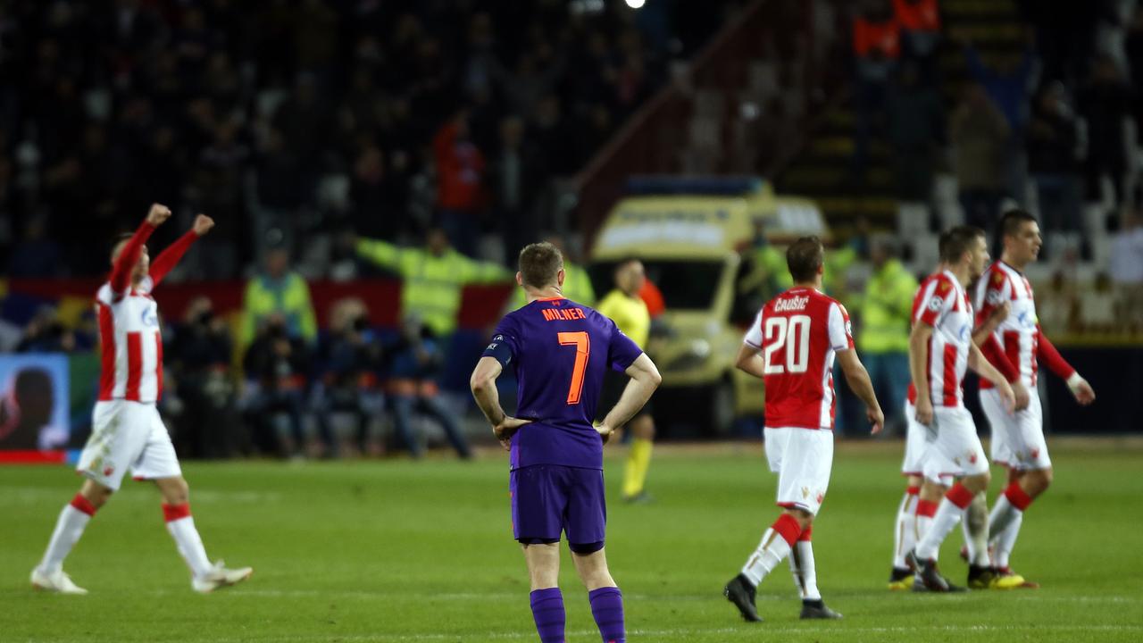 Liverpool midfielder James Milner looks in dejection as Red Star celebrate