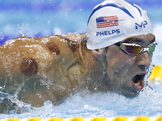 USA's Michael Phelps competes in a Men's 200m Butterfly heat during the swimming event at the Rio 2016 Olympic Games at the Olympic Aquatics Stadium in Rio de Janeiro on August 8, 2016. / AFP PHOTO / Odd Andersen