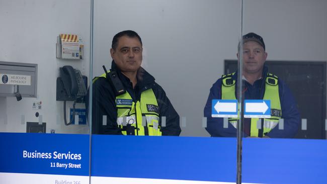 Security at the university building where hearings are taking place. Picture: Jason Edwards