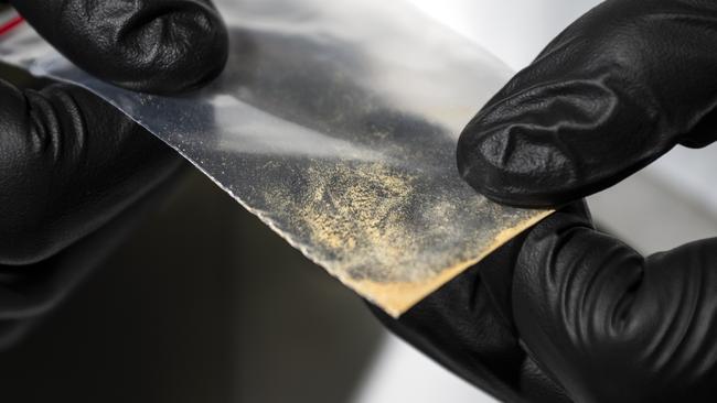 Alex Krotulski, 32, associate director and forensic toxicologist, holds a nitazene powder sample at the Center for Forensic Science Research and Education on Friday, Oct. 20, 2023, in Willow Grove, Pa. Nitazenes are a class of synthetic opioids typically sold as heroin and are estimated to be several times more potent than fentanyl.(Photo by Joe Lamberti for The Washington Post via Getty Images)