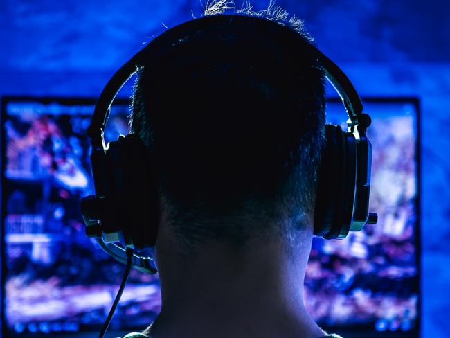 Men wearing headphones playing video games late at night Picture: Istock
