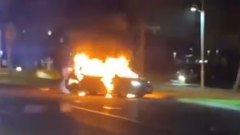 A screengrab from a video showing a Toyota Corolla well ablaze on The Strand in Townsville on Saturday night.