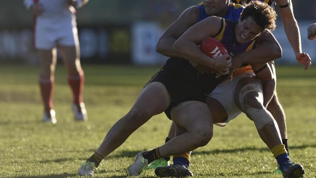 Adam Gibson is taken in a tackle. Picture: Christopher Chan.