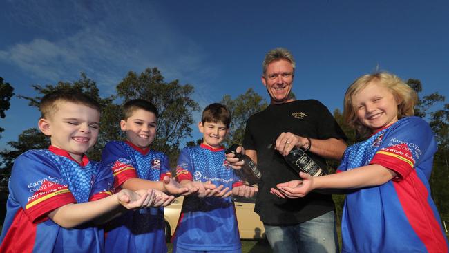 Junior football is back with thanks to David Ridden from Grandad Jacks, a sanitiser company that has helped get players back on the pitch. Robina players from left,Lucas Foweraker, Isaac Foweraker, Bill Barber, Logan Schoor, get some clean hands from David Ridden. Picture Glenn Hampson