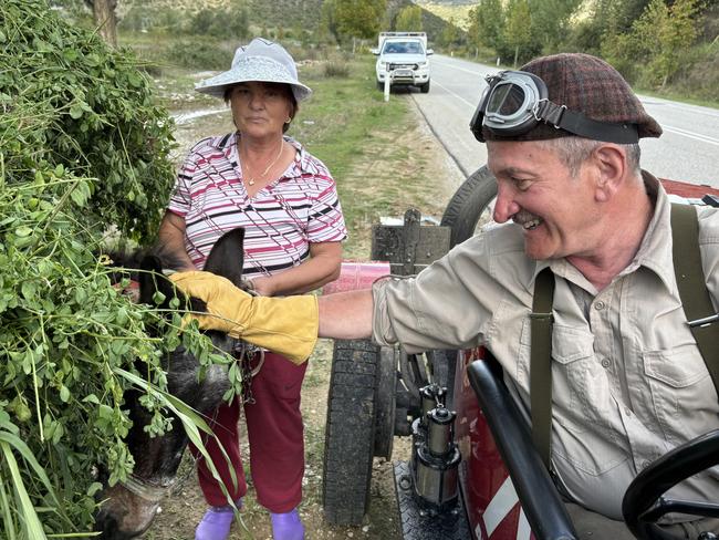 Warren Brown makes friends with a local and her donkey in Albania.