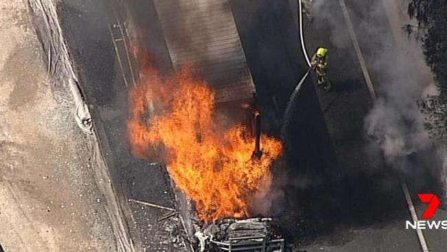 Firefighters battle the blazing vehicle on the M5 today. Picture: Seven News