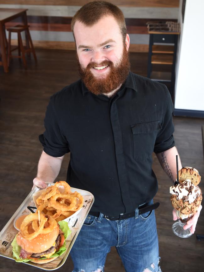 Kurt Van Velzen with a choc cookie shake and The Nod Burger with onion rings at On It Burgers in Ferntree Gully. Picture: Steve Tanner