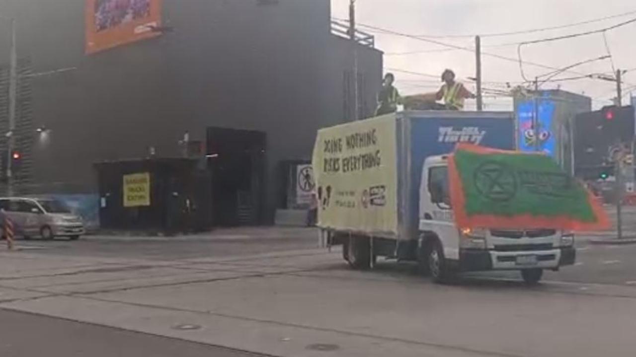 Two protesters sitting are on top of the truck. Picture: Facebook