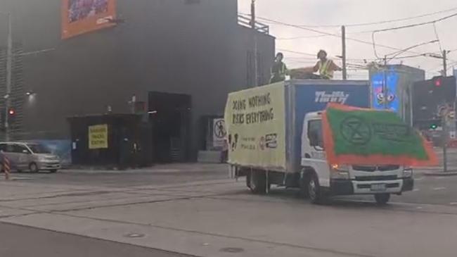 Two protesters sitting are on top of the truck. Picture: Facebook