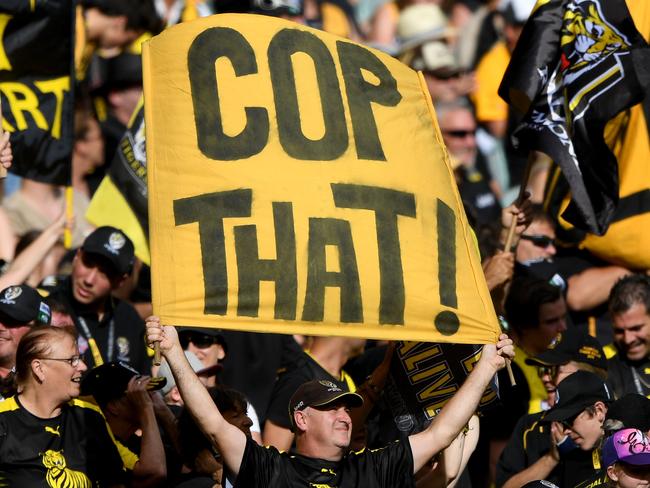 Tiger fans celebrate a goal during the Round 3 AFL match between the Richmond Tigers and the Hawthorn Hawks at the MCG in Melbourne, Sunday, April 8, 2018. (AAP Image/Joe Castro) NO ARCHIVING, EDITORIAL USE ONLY