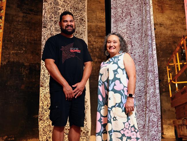 The Cairns Indigenous Art Fair will commence its 2024 program, with the satellite exhibition Not Selling Cakes: Celebrating CIAF's 15th Anniversary opening at the on Friday. CIAF Curatorial Assistant Teho Ropeyarn and Artistic Director Francoise Lane appreciate the works of CIAF's foundation artists at the Tanks Arts Centre as the exhibition is installed. Picture: Brendan Radke