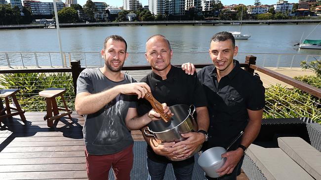 Stavros Georges, Patrick Panier and Nick Pavlakis (far right) at Medley Cafe when it opened in Kangaroo Point. Picture: Annette Dew