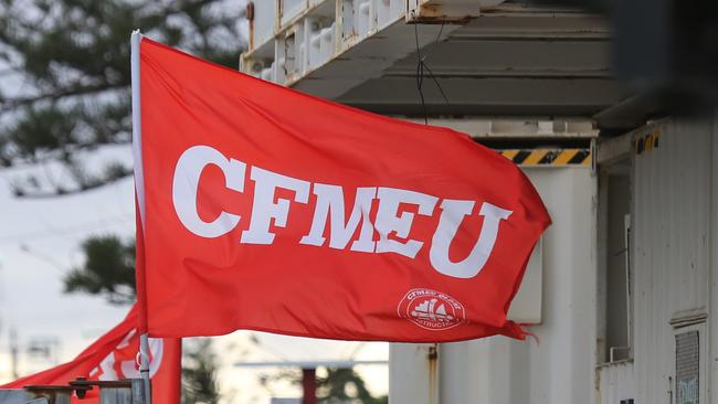 Workers on The Jewel site this afternoon. CFMEU flag still flying at this stage. Picture Glenn Hampson