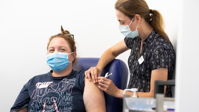 A nurse administers the AstraZeneca COVID-19 vaccine to a patient at the Austin Hospital.